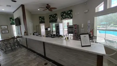 a large kitchen with a bar with a table at Spectacular Lake View - Game Room- Close to Disney in Kissimmee