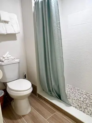 a bathroom with a toilet and a shower at Unit near Epic Universe and Universal Studios - free parking in Orlando