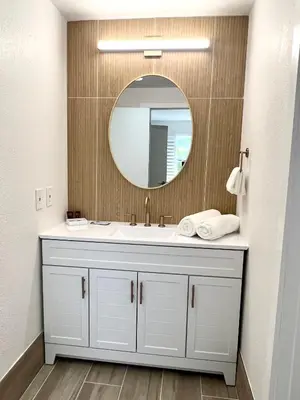 a bathroom with a white sink and a mirror at Unit near Epic Universe and Universal Studios - free parking in Orlando