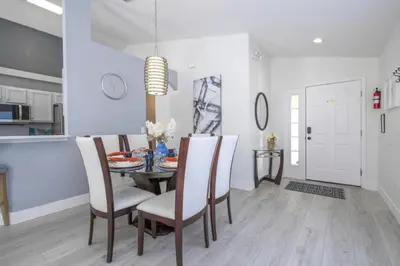a kitchen and dining room with a table and chairs at Sunshine Escape 20 minutes from Disney in Kissimmee