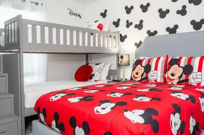 a bedroom with a red bedspread with cows on it at Stunning 4Bd Close to Disney at Storey Lake Resort 2569 in Kissimmee