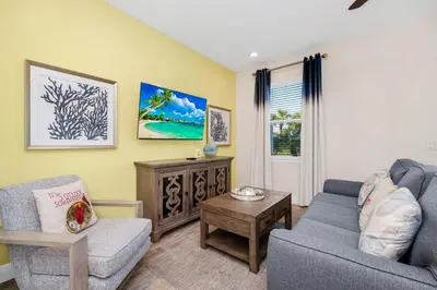 a living room with a couch and a chair at Tranquil Villa Near Disney With Margaritaville Resort & Island H20 Waterpark Access - 2928Cs in Orlando