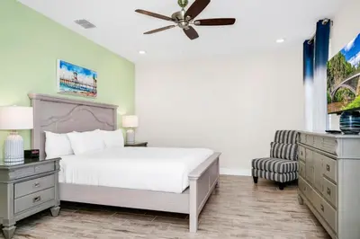 a bedroom with a bed and a ceiling fan at Tranquil Villa Near Disney With Margaritaville Resort & Island H20 Waterpark Access - 2928Cs in Orlando