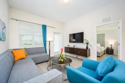 a living room with a couch and chairs and a tv at Epic Universe New Modern Vista Cay Reserve Condo - 5005 in Orlando
