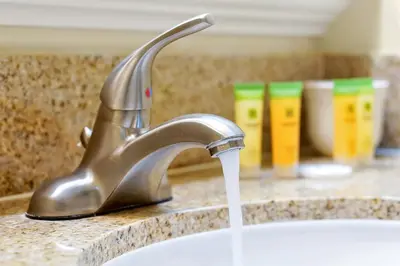a sink with water coming out of a faucet at Living the Disney Dream! Lake View Luxury Condo in Orlando