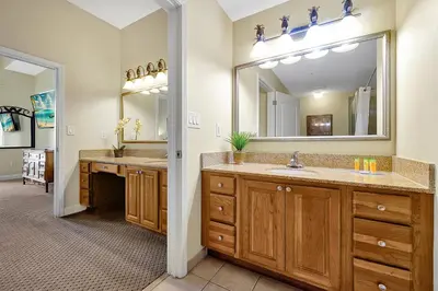 a bathroom with two sinks and a large mirror at Living the Disney Dream! Lake View Luxury Condo in Orlando