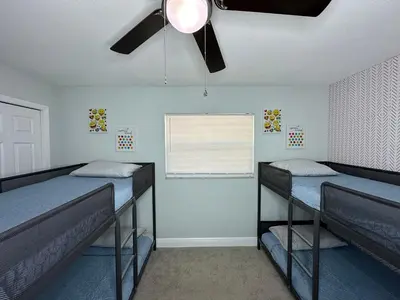 two bunk beds in a room with a window at Orlando Luxe Retreat with Private Pool in Orlando