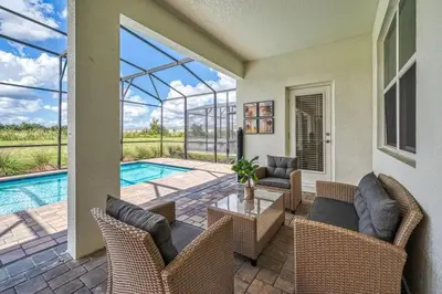 a patio with a table and chairs and a swimming pool at 6Q/6B | Piscina Privativa | Game Room Temático in Kissimmee