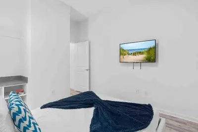a living room with a tv hanging on the wall at SUPER RITZY - 9BDRs-9BAs w Theme Rooms LOFT & POOL in Orlando