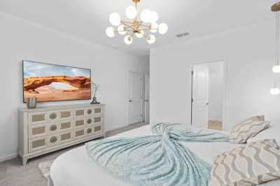 a bedroom with a bed and a television on a dresser at SUPER RITZY - 9BDRs-9BAs w Theme Rooms LOFT & POOL in Orlando