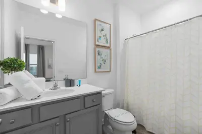 a bathroom with a sink and a toilet and a mirror at SUPER RITZY - 9BDRs-9BAs w Theme Rooms LOFT & POOL in Orlando