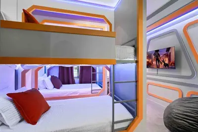 a bedroom with two bunk beds in a bus at SUPER RITZY - 9BDRs-9BAs w Theme Rooms LOFT & POOL in Orlando