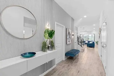 a hallway with a mirror and a blue chair at SUPER RITZY - 9BDRs-9BAs w Theme Rooms LOFT & POOL in Orlando