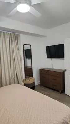 a bedroom with a bed and a dresser and a mirror at Orlando Blue Heron 1 Mile From Disney 2nd floor in Orlando