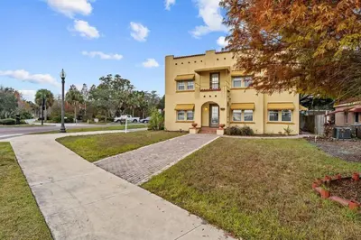 a large yellow house with a driveway at SUPER BOHO - LAKE TOHO FISHiNG WATER FRONTs in Kissimmee