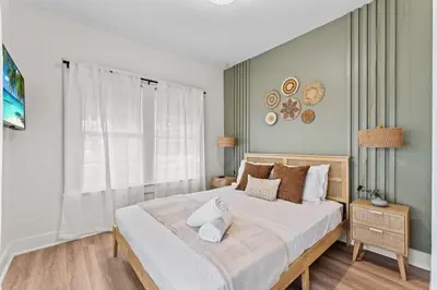a bedroom with a large bed and a window at SUPER BOHO - LAKE TOHO FISHiNG WATER FRONTs in Kissimmee