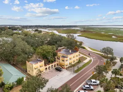 an aerial view of a building next to a river at SUPER BOHO - LAKE TOHO FISHiNG CIVIC CeNTER in Kissimmee