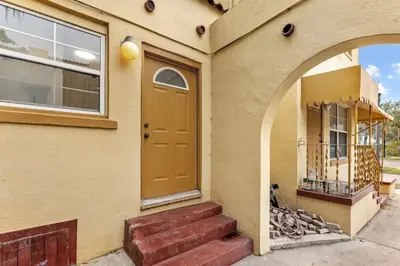 a house with a orange door and a window at SUPER BOHO - LAKE TOHO FISHiNG CIVIC CeNTER in Kissimmee