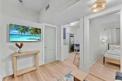 a living room with a bed and a table at SUPER BOHO - LAKE TOHO FISHiNG CIVIC CeNTER in Kissimmee