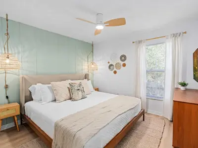 a bedroom with a bed and a ceiling fan at SUPER BOHO- At LAKE TOHO's WATER SLEEPs 6 in Kissimmee