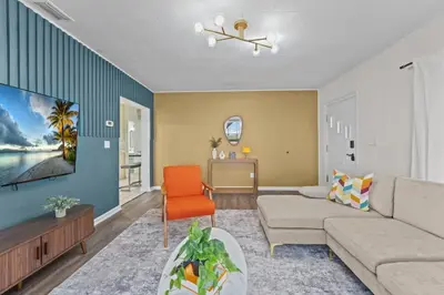 a living room with a couch and a chair at SUPER BOHO - At Lake Toho Fishing VINTaGE VIBEs in Kissimmee