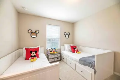 a bedroom with two beds with stuffed animals on them at SUPER CHIC - 4 Bedroom TOWNHOME IN DISNEY AREA in Kissimmee