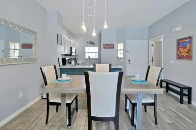 a dining room and kitchen with a table and chairs at Encantada Resort - Spacious 3-Bedroom Villa with Private Pool Near Disney in Kissimmee