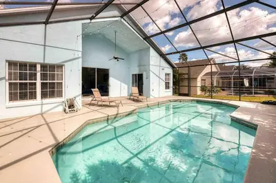 a large swimming pool with a glass ceiling at SUPER GLAM - GAME ROOM and POOL in Orlando
