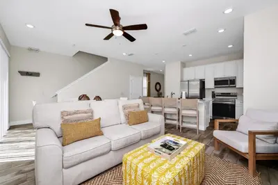 a living room with a white couch and a ceiling fan at Sky Blue Villa Near Disney With Margaritaville Resort & Island H20 Waterpark Access - 3156Cs in Orlando
