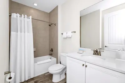 a white bathroom with a sink and a toilet at Sky Blue Villa Near Disney With Margaritaville Resort & Island H20 Waterpark Access - 3156Cs in Orlando