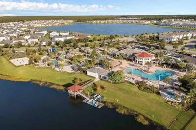 an aerial view of a resort on the water at SUPER DOPE- Home w POOL & AMENITIEs in Kissimmee