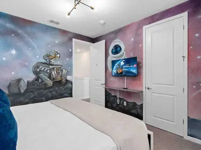 a bedroom with a astronaut mural on the wall at Super Huge- 12BD 12BAs - Sleeps 38 in Kissimmee