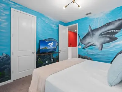 a bedroom with a shark mural on the wall at SUPER SPACE - 12BD 12BA - MANY ENSUITEs SLEEPs 38 in Kissimmee