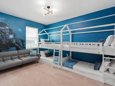 a room with two bunk beds and a couch at SUPER SPACE - 12BD 12BA - MANY ENSUITEs SLEEPs 38 in Kissimmee
