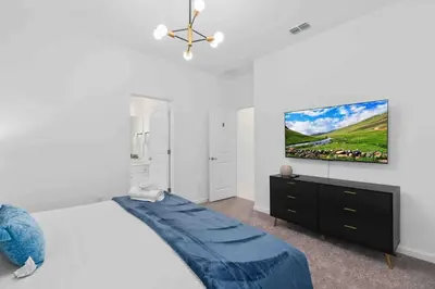 a bedroom with a bed and a tv on a wall at SUPER FANCY- 15BDR 17BAs HUGE 7 000SQFT HOME in Kissimmee