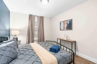 a bedroom with a bed and a window at SUPER POSH- SLEEPs 16 wDESIGNs & NEAR Disney in Kissimmee