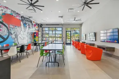 a restaurant with tables and chairs in a cafeteria at SUPER CIELO - 12BDR 11BAs - FUN THEME w POOL in Orlando