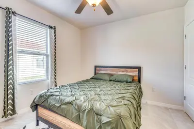 a bedroom with a bed and a ceiling fan at 7 Mi to USTA Waterfront Tennis House with Yard! in Kissimmee