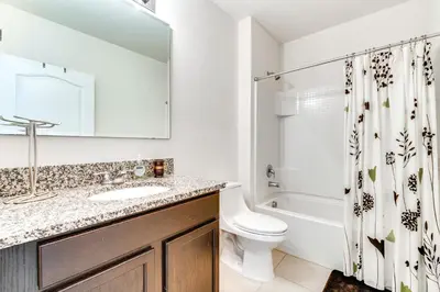 a bathroom with a sink and a toilet and a shower at 7 Mi to USTA Waterfront Tennis House with Yard! in Kissimmee