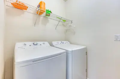 a laundry room with a washer and a drying rack at 7 Mi to USTA Waterfront Tennis House with Yard! in Kissimmee
