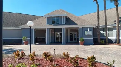 a building with palm trees in front of it at Two bed condo in Parkway Palms Resort condo in Orlando