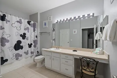 a bathroom with a sink and a toilet and a shower curtain at Cw7671-205 3Br Condo in Orlando