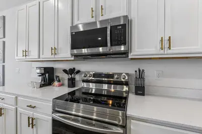 a kitchen with a stove and a microwave at 295 Marcello Blvd in Kissimmee