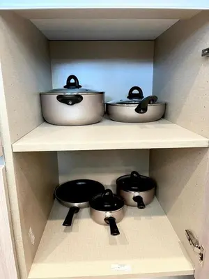four pots and pans on a shelf in a kitchen at Serenity Townhome Getaway 4 bed 3 bath home near Disney in Clermont FL in Orlando