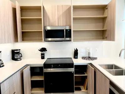 a kitchen with a black stove and a microwave at Serenity Townhome Getaway 4 bed 3 bath home near Disney in Clermont FL in Orlando