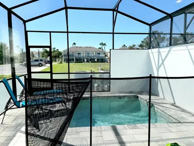 a glass house with a swimming pool and a patio at Serenity Townhome Getaway 4 bed 3 bath home near Disney in Clermont FL in Orlando