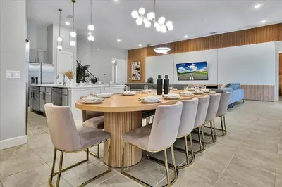 a dining room and kitchen with a table and chairs at Gorgeous Paradiso Mansion Pool-Game-Room-Theater-3 in Orlando