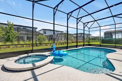 a swimming pool in a building with a large glass enclosure at Gorgeous Paradiso Mansion Pool-Game-Room-Theater-3 in Orlando