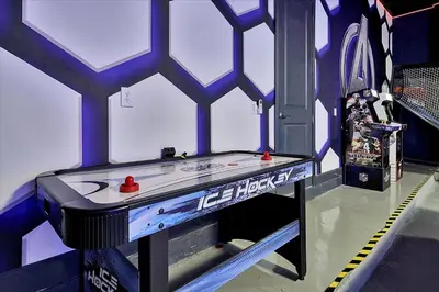 a ping pong table in a room with a skateboard at Gorgeous Paradiso Mansion Pool-Game-Room-Theater-3 in Orlando