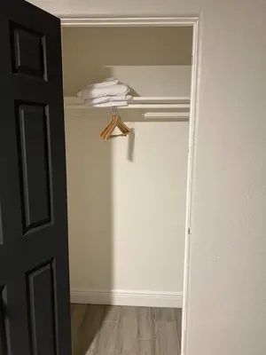 a room with a closet with a towel on a shelf at City and Stadium Sanctuary Vibes in Orlando